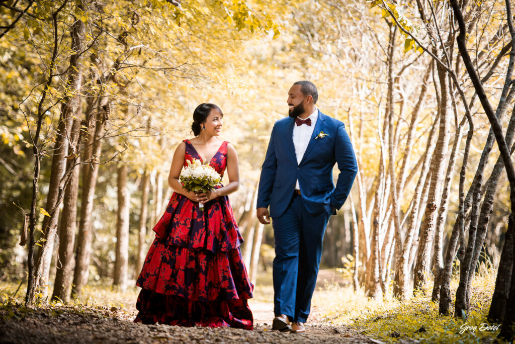 Sesión de fotos pre boda o novios en el Parque Humedales del Ozama en Santo Domingo, República Dominicana por el fotografo dominicano Greg Dotel Photography. Fotos de novios en el parque con traje de novia rojo con flores y traje de caballero.